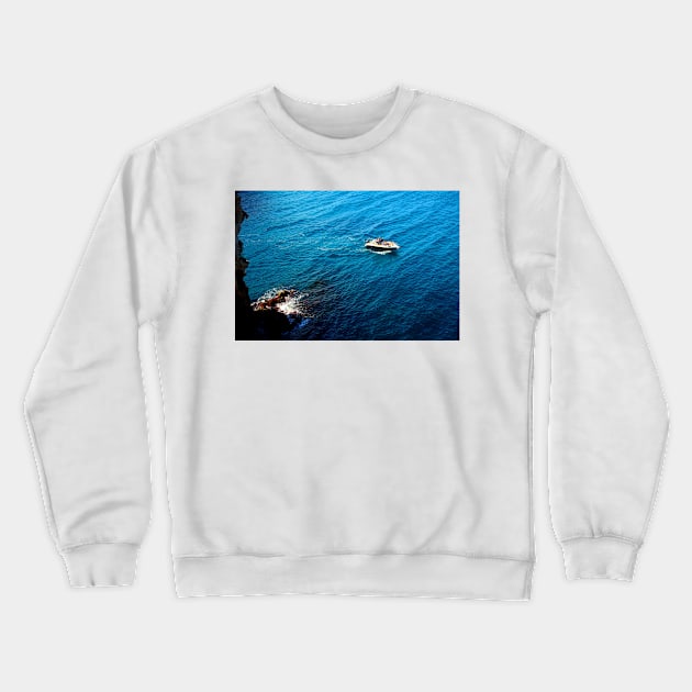 View from a high rocky shore of Polignano a Mare at a boat in the Adriatic sea Crewneck Sweatshirt by KristinaDrozd